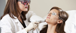 The beautician performing the procedure of laser resurfacing